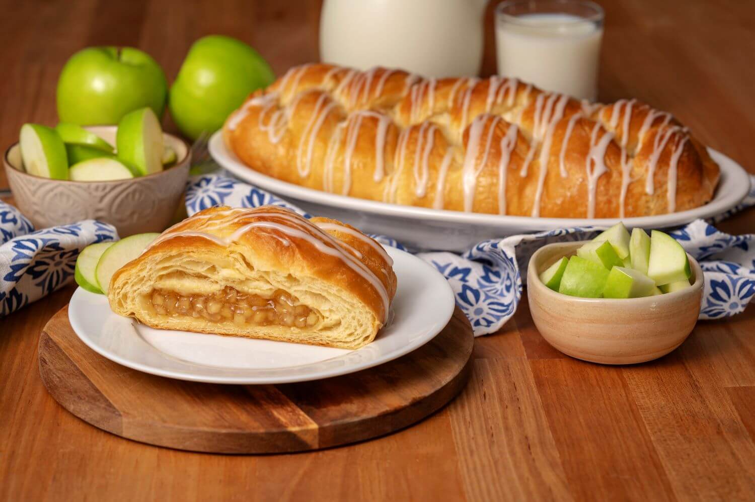 Strawberry and Cream Cheese Butter Braid Pastry with slice on plate next to fork and whole strawberries