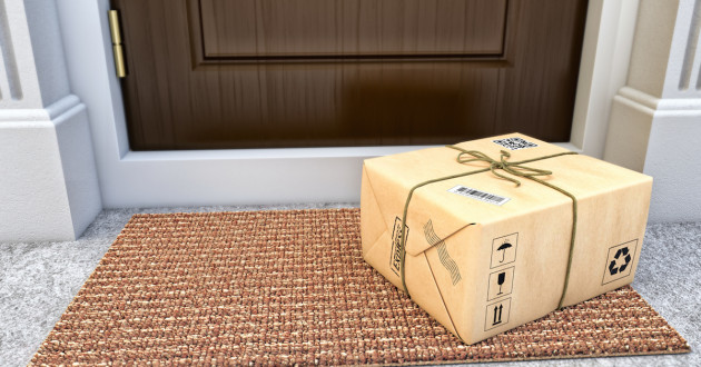 shipping box on mat by the front door