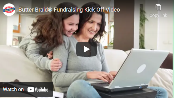 Mom and daughter at a laptop on the couch. Has the play video icon over top